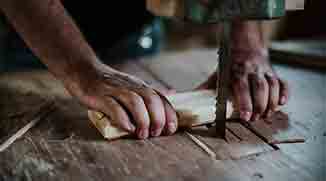 Handyman repairing damaged wooden flooring